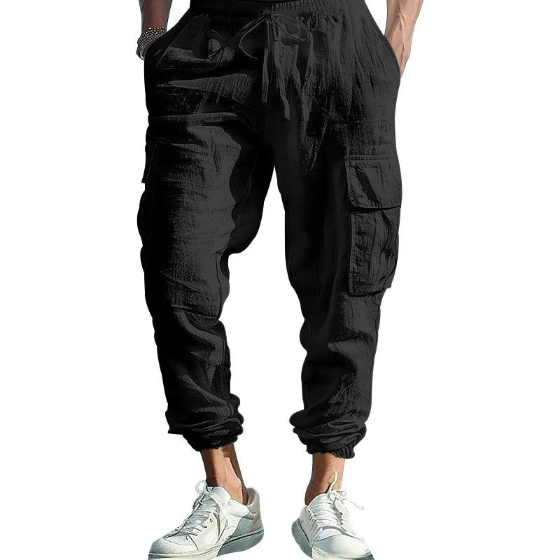 Men's solid colour linen casual trousers with ankle ties and drawstring waist on hanger.