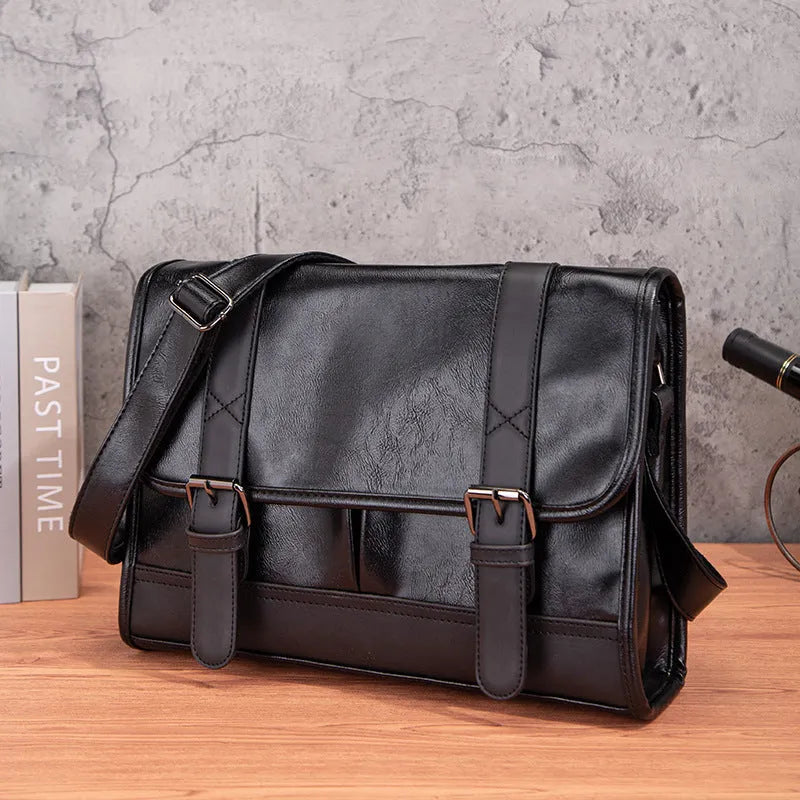 Black polyurethane commuter backpack with contrast stitching and anti-theft features