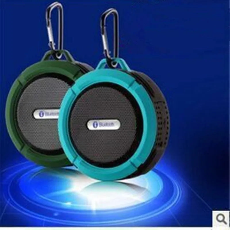 Portable waterproof Bluetooth speaker with carabiner clip in black, blue, green, red, or yellow colours