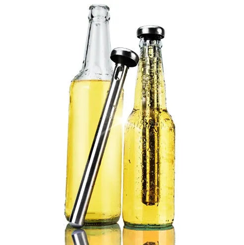 Silver stainless steel wine cooling rod with pourer next to a red wine bottle
