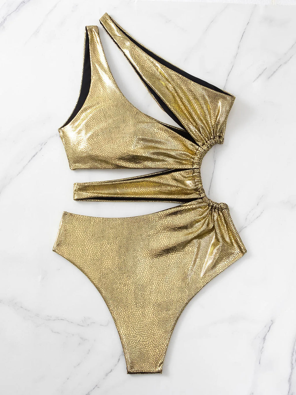 Women's solid gold backless one-piece swimsuit on a model.