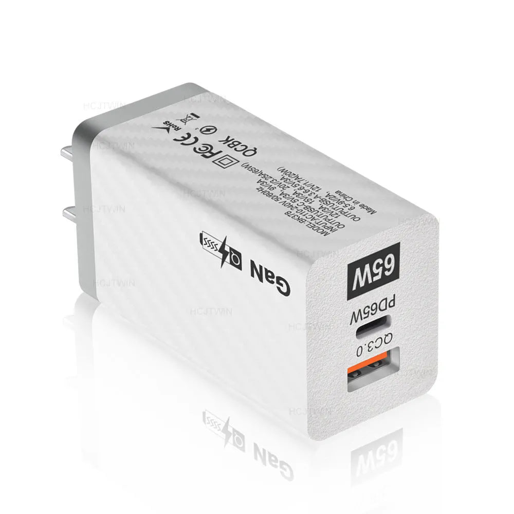 65W GaN fast charger showing compact size next to laptop with USB-C cable