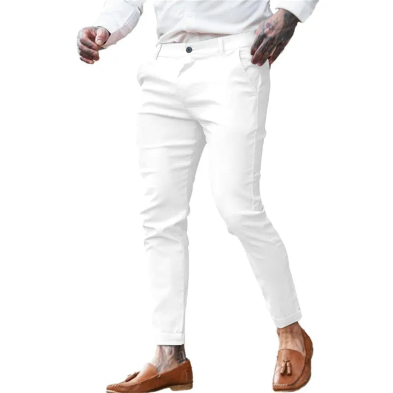 Men's slim fit stretch cotton twill pencil trousers on a hanger, shown in apricot colour.