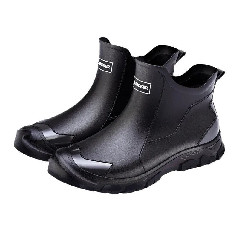 Short black PVC wading boots with a round toe and flat heel on a white background.