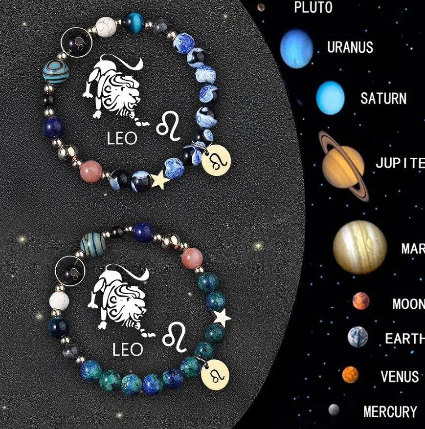 Two natural stone beaded bracelets with zodiac sign charms on a wooden surface.