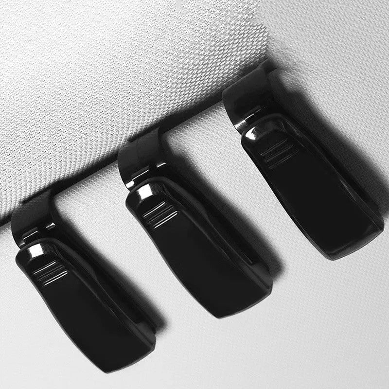 Black plastic car sunshade clip for organising glasses, tickets and identification cards