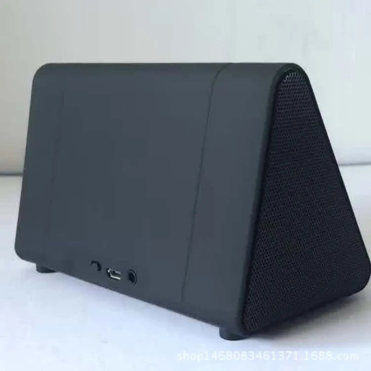 Mobile phone stand speaker in black with phone resting on stand showing speaker grille