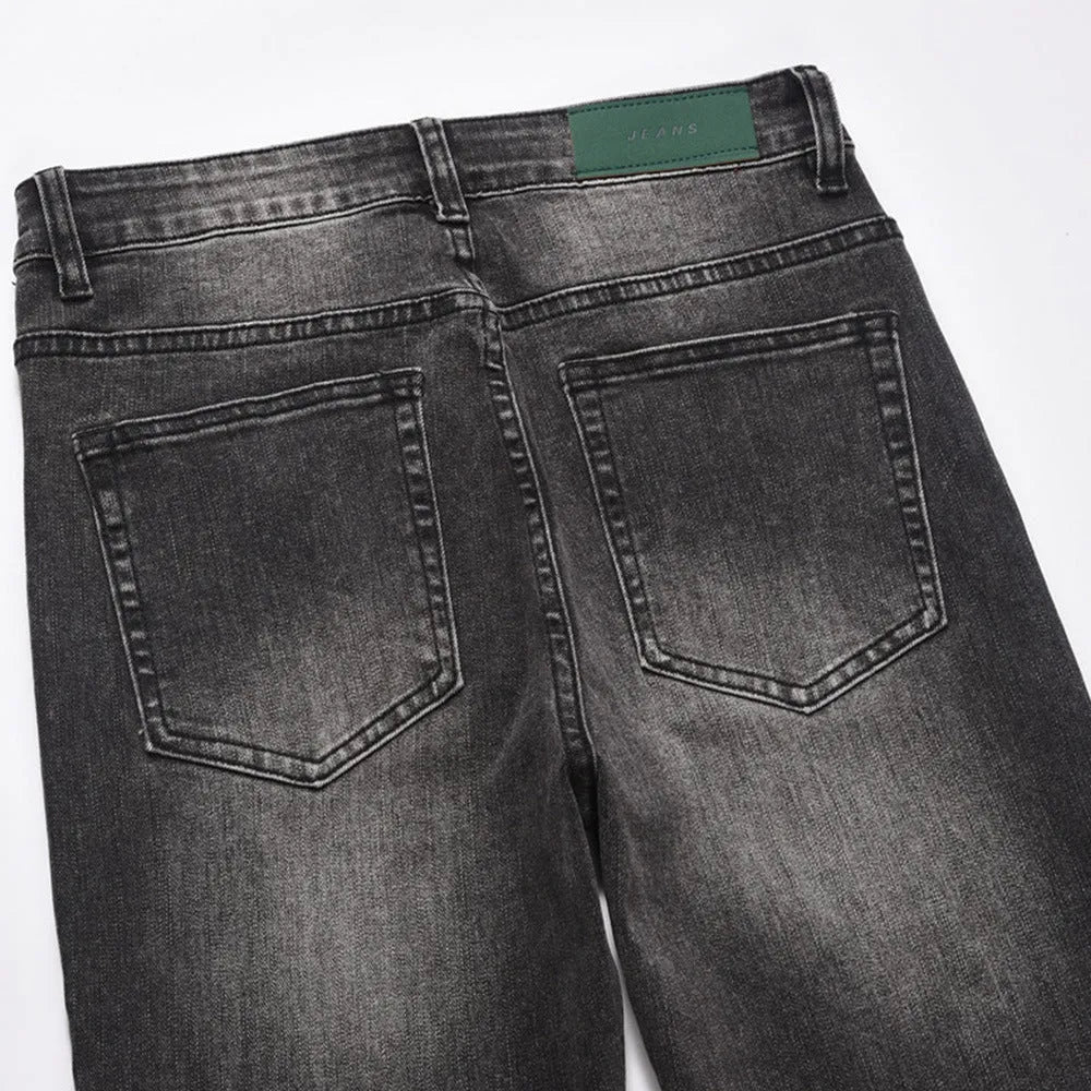 Men's black washed wear-white denim jeans on a plain background showing front view