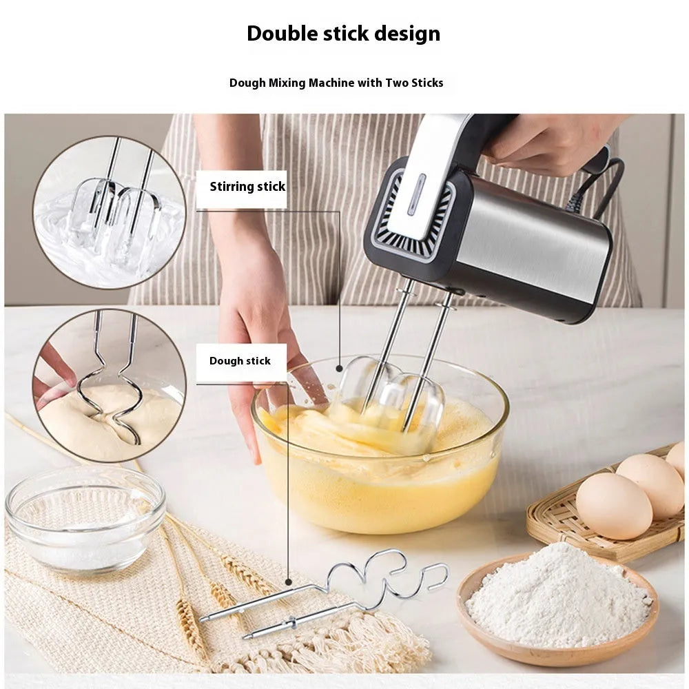 Silver mini electric hand whisk with stainless steel beaters on a kitchen counter.