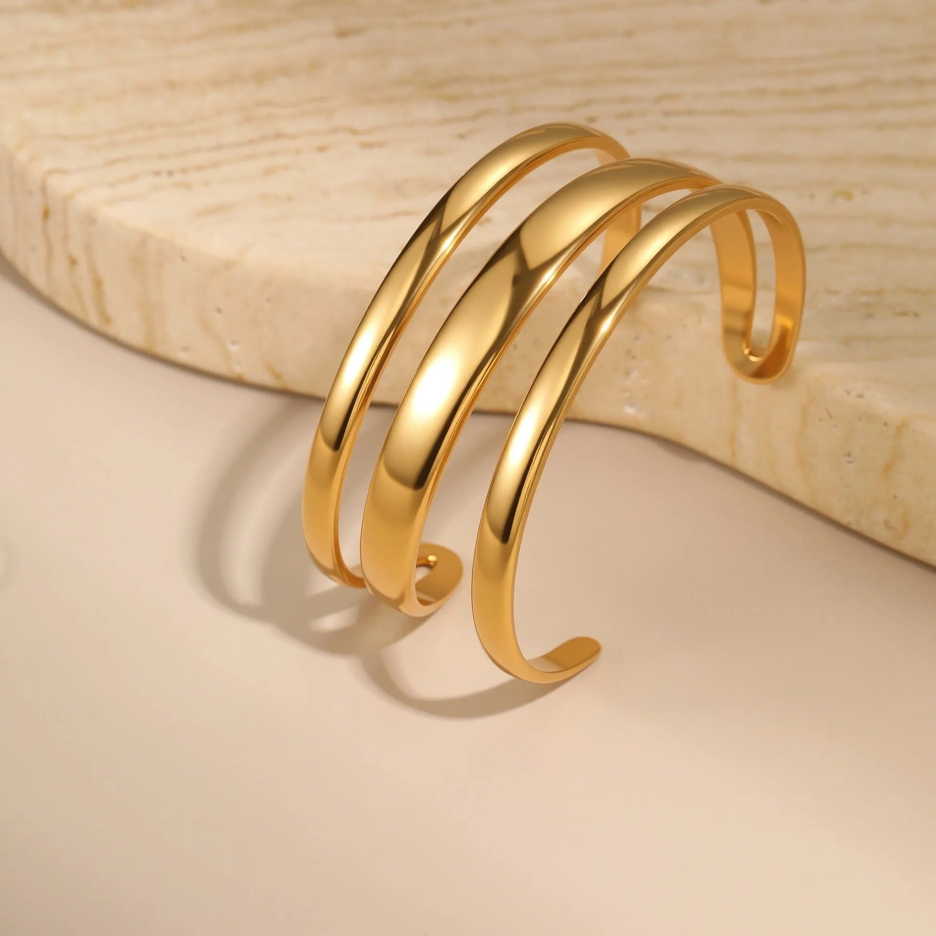 Women's stainless steel geometric bracelet with simple opening in gold or steel electroplated finish.