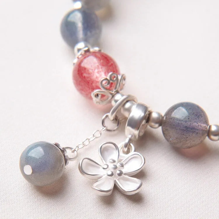 Women's silver bracelet with 7.5mm gray moonlight stone and zodiac design.