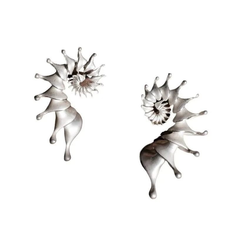 A pair of three-dimensional matte finish conch shell stud earrings in alloy with irregular shaping.