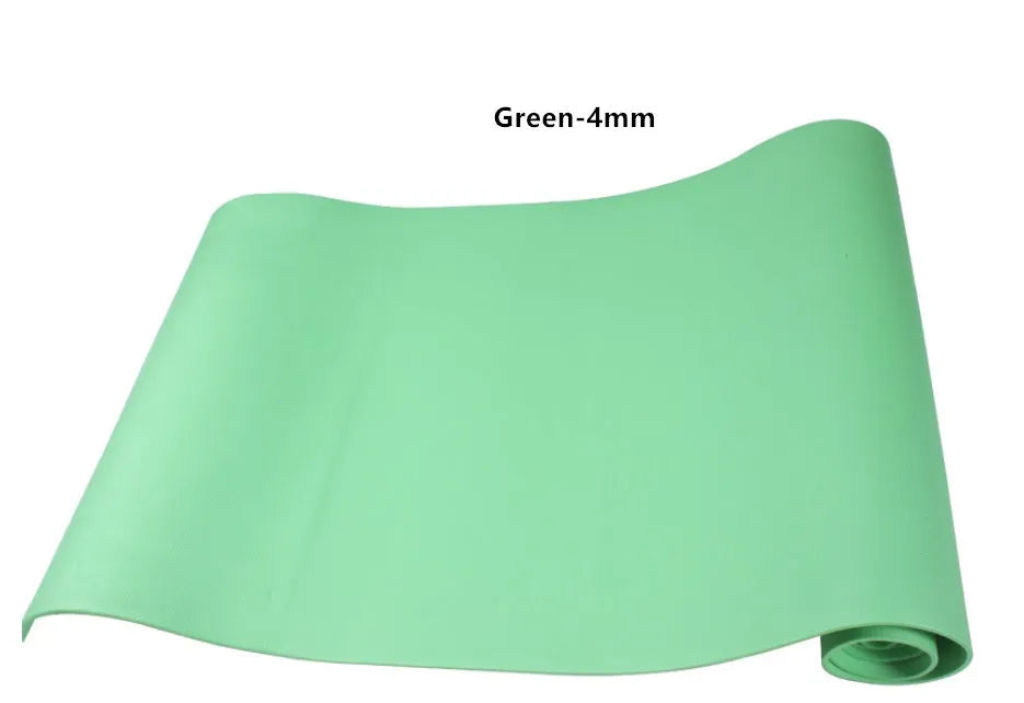 Red EVA fitness yoga mat with rolled edge showing thickness, laid flat on a wooden floor.