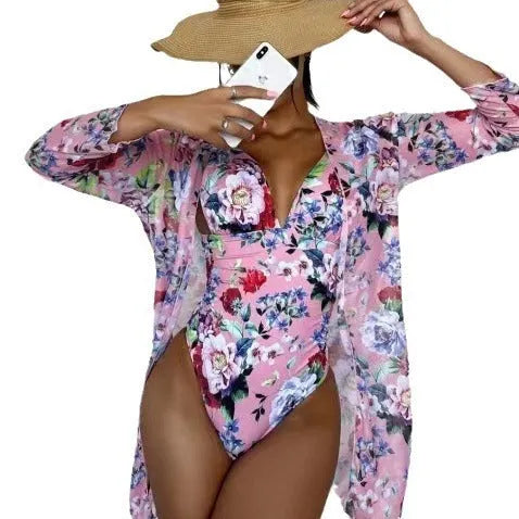 Women's floral patterned tight bikini three-piece swimsuit set with a cover-up coat.