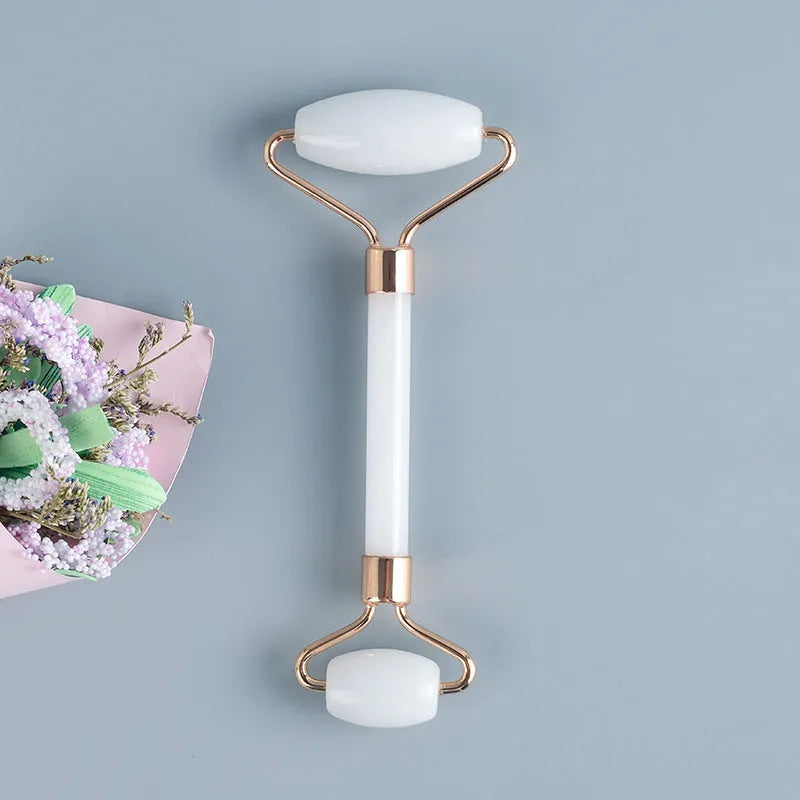 White jade dual-head facial roller and gua sha tool with a separate massage board on a plain background.