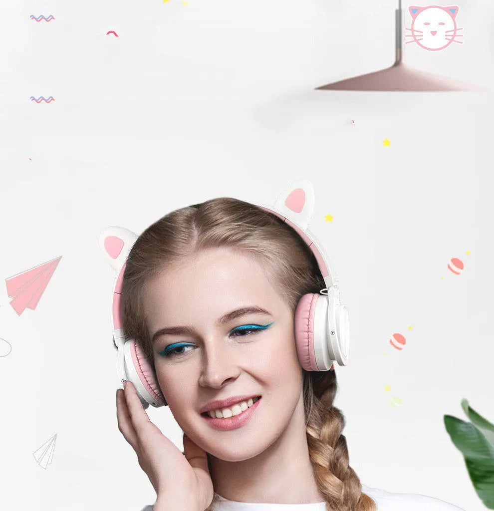 Pink and white Bluetooth over-ear headphones with braided cable and built-in microphone