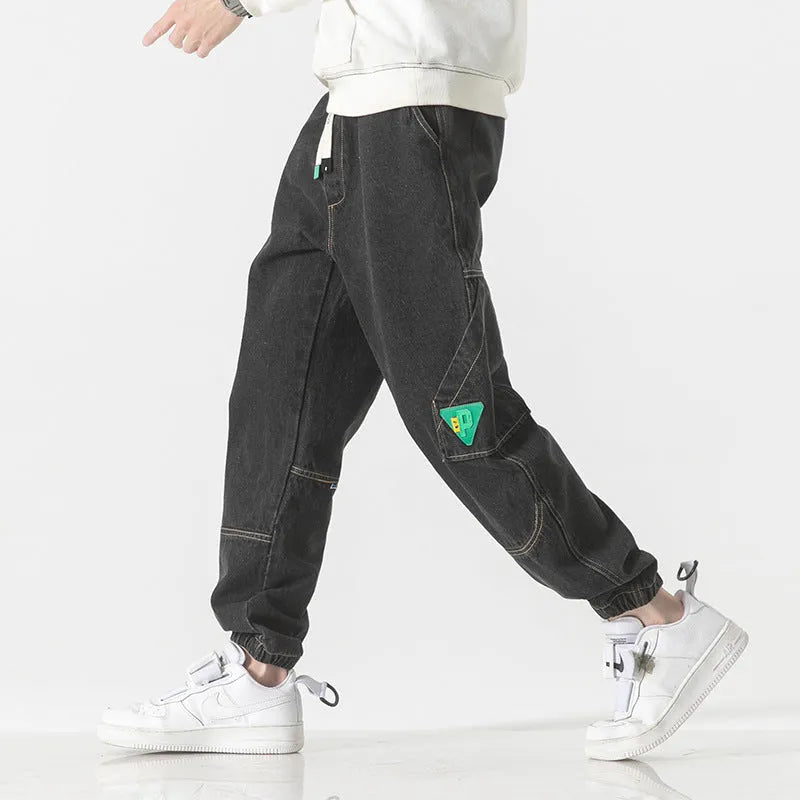 Men's loose-fit tapered trousers in cotton fabric showing mid waist design and tapered leg cut