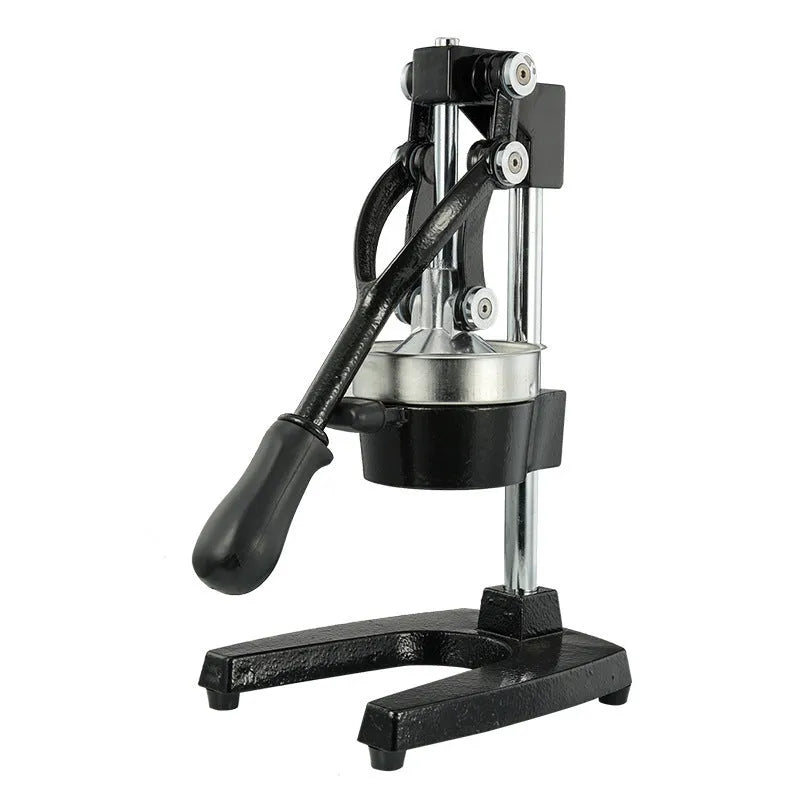 Black or white cast iron manual citrus juicer with stainless steel funnel on a kitchen counter.