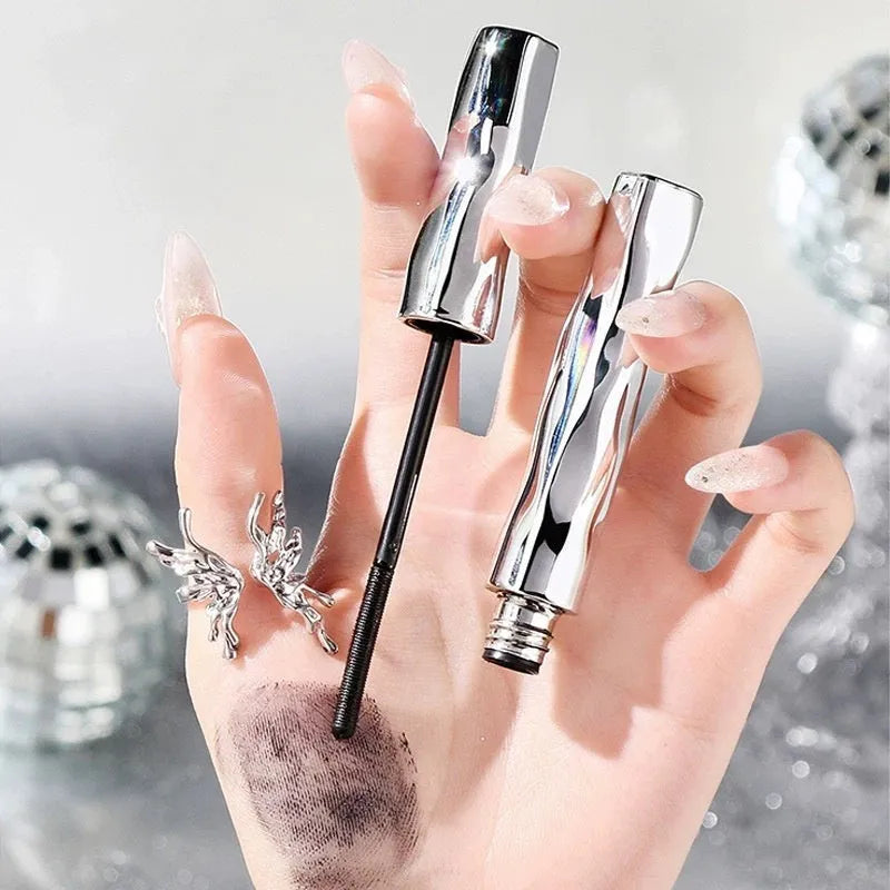 Waterproof mascara in a steel tube with choice of black or brown shade, shown with optional eyelash curler.