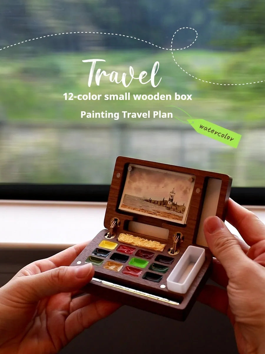 Miniature wooden watercolour paint box on a table, showcasing its compact size and walnut finish.