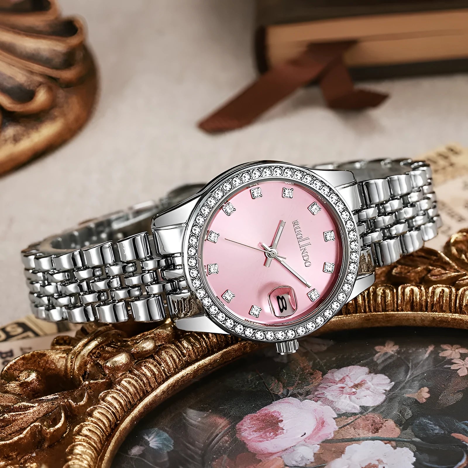 Silver women's alloy watch with circular 32mm dial and stainless steel folding buckle.