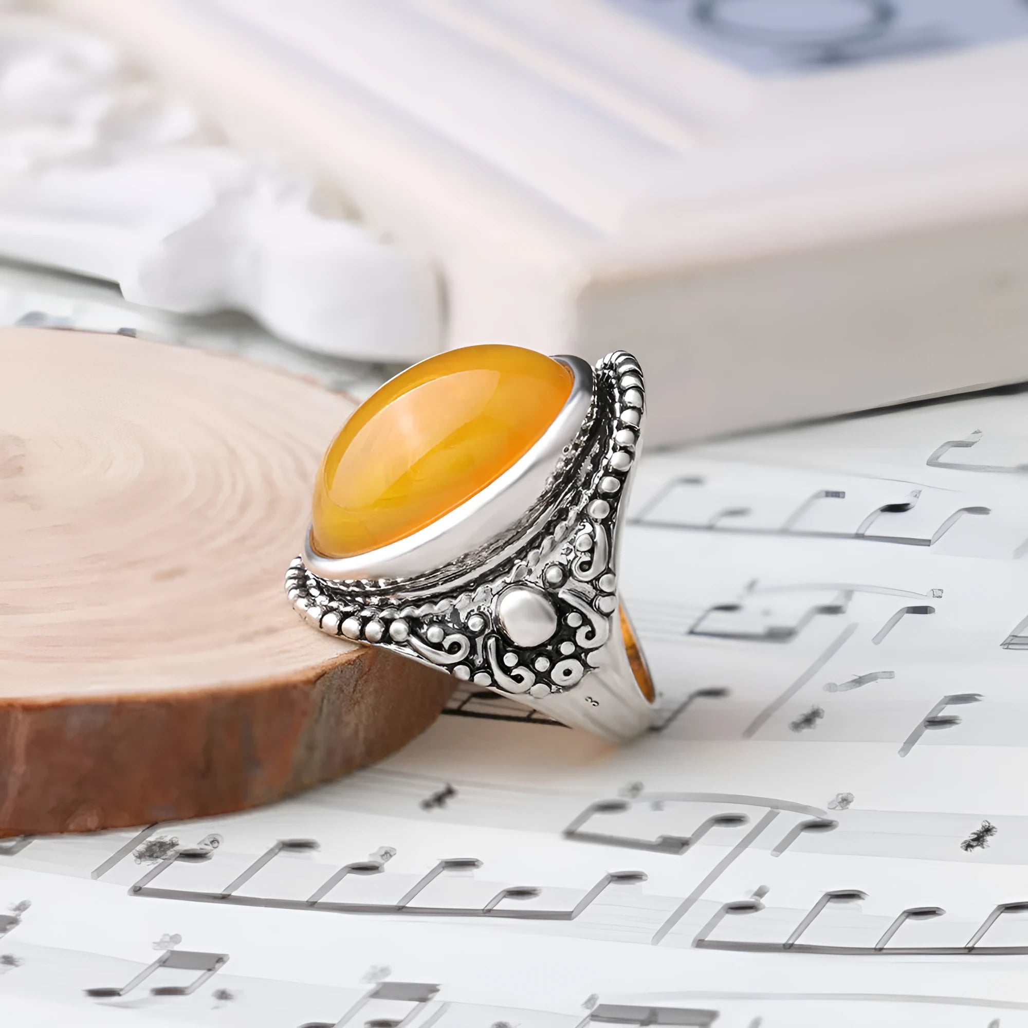 Geometric fluorescent beeswax alloy ring in antique silver amber colour on a grey background.