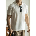 Men's blue cotton blend short-sleeve polo shirt on a hanger, showing the collar and regular fit.
