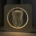 Wood-colour tooth-shaped acrylic USB night lamp on a surface