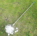 Metallic coloured golf ball picker made from stainless steel on a green