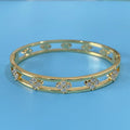 Gold and silver hollow women's bracelets with inlaid zircon stones and four-leaf clover designs.