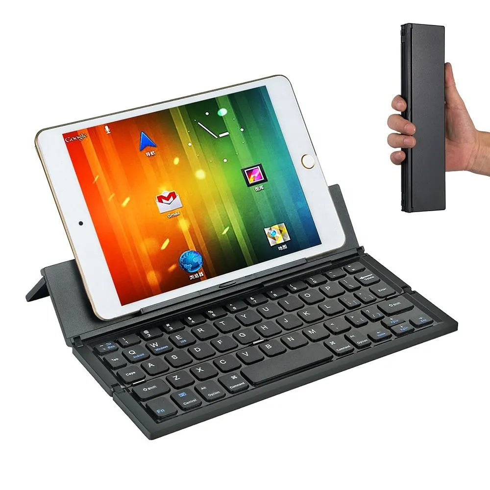 Black folding Bluetooth keyboard with aluminium bottom next to tablet
