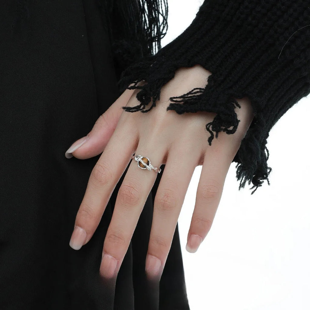 Saturn-themed adjustable open ring in electroplated white gold colour with tigereye gemstone detail