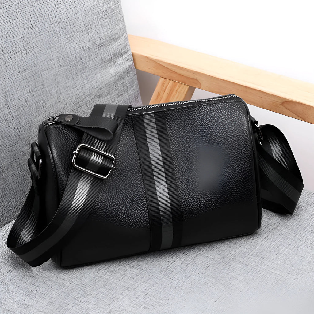 Black genuine leather one-shoulder crossbody bag showing 24x16x13cm dimensions and polyester lining interior