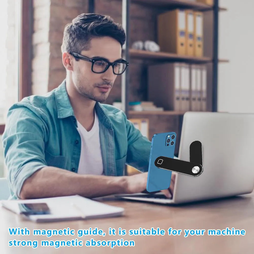 Black aluminium laptop phone holder with magnetic mount attached to a monitor showing a smartphone in place