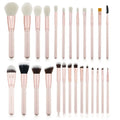 26 pink makeup brushes with wooden handles laid out next to a matching storage bag.