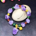 Natural amethyst bracelet with fu charm on woman's wrist