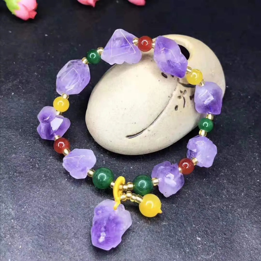 Natural amethyst bracelet with fu charm on woman's wrist