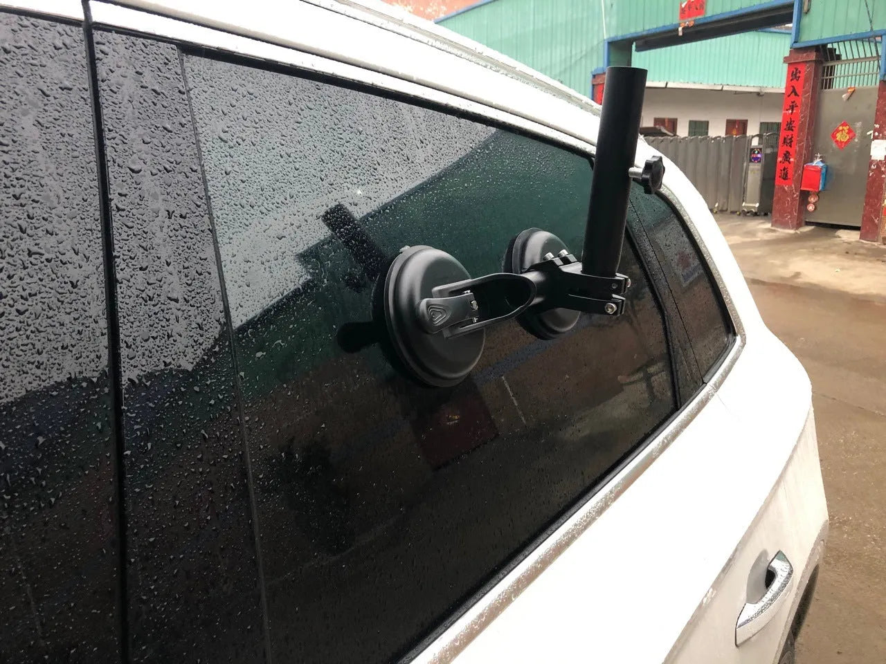 Black off-road car sucker mount with rubber suction cup for attaching flags to vehicle windows.