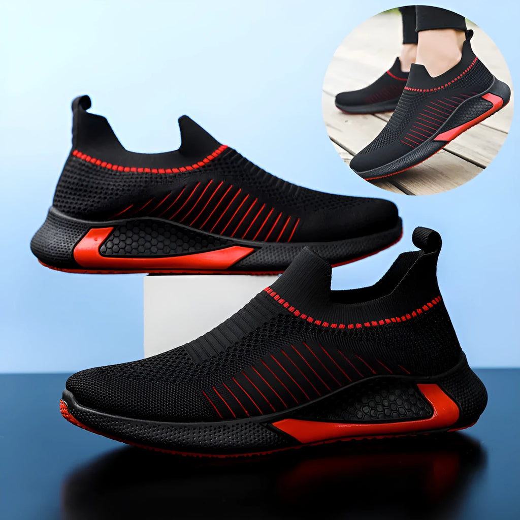 Men's black and white mesh slip-on sneakers with striped design and flat sole.