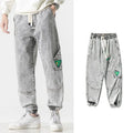 Men's loose-fit tapered trousers in cotton fabric showing mid waist design and tapered leg cut