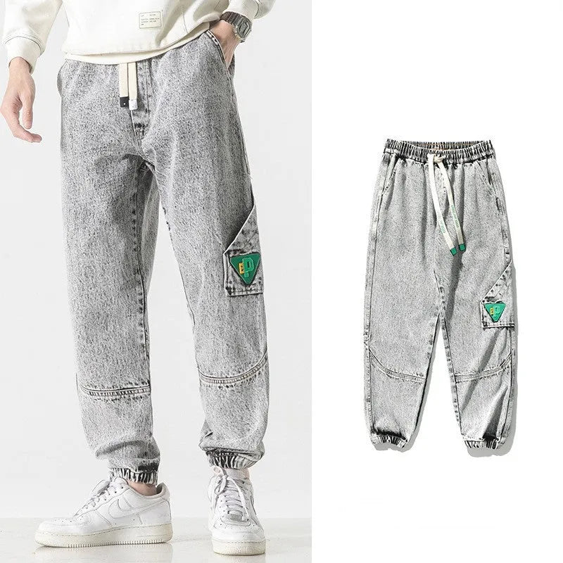 Men's loose-fit tapered trousers in cotton fabric showing mid waist design and tapered leg cut