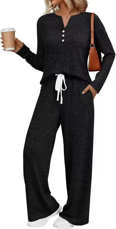 Woman wearing a striped V-neck knit long coat with lace-up detail and pants from a casual streetwear set.