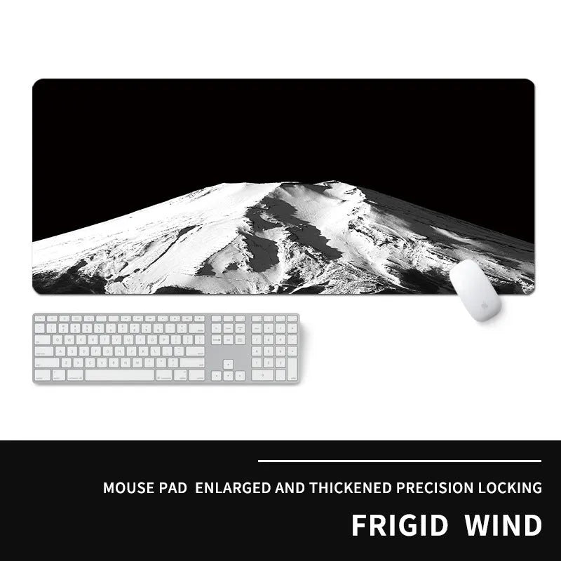 Oversized gaming mouse pad with graphic design on a desk with keyboard.