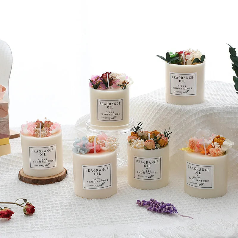 Decorative dried flower aromatherapy candle on a wooden chip base, shown with a gift box.
