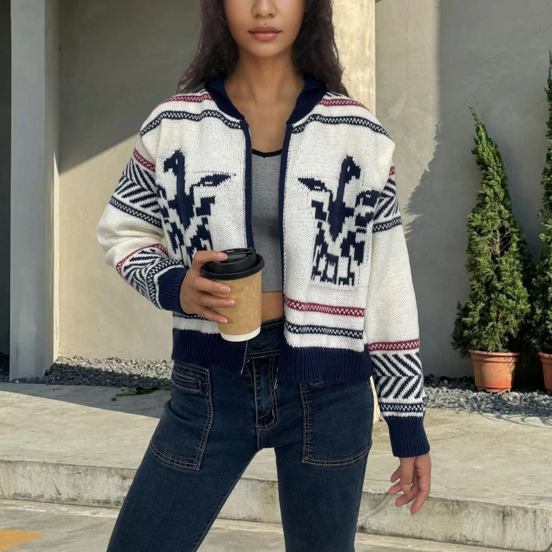 White women's cardigan with front zip, lapel collar, and jacquard contrast stripe pattern.