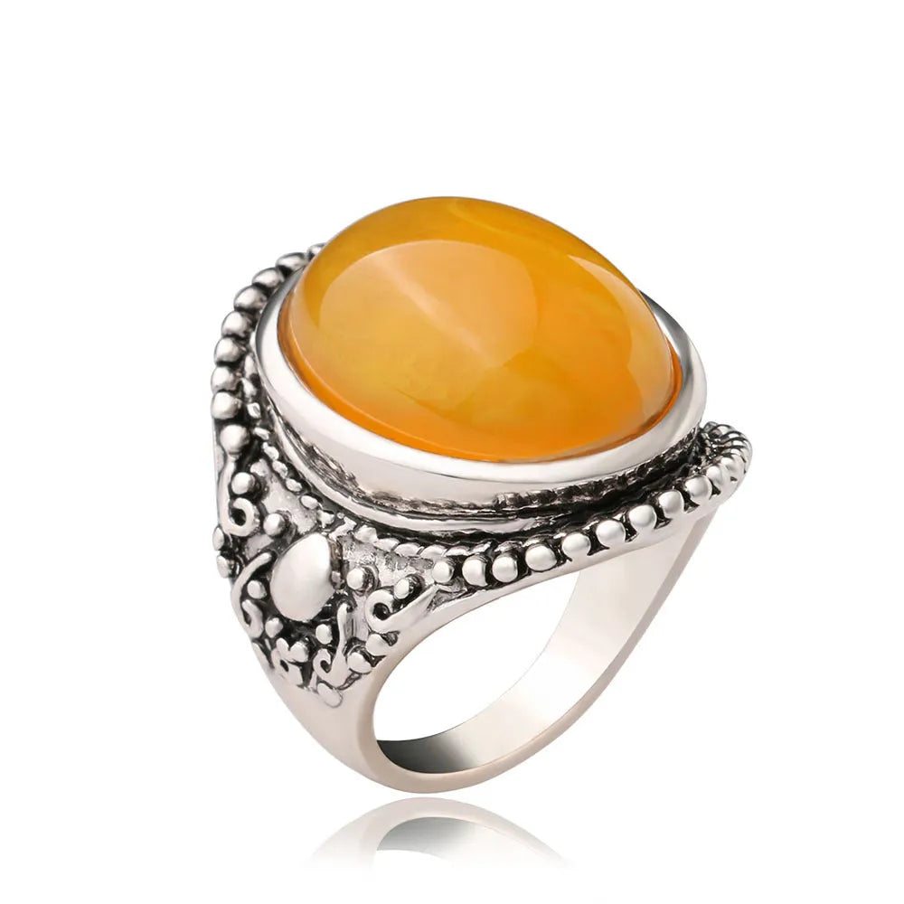 Geometric fluorescent beeswax alloy ring in antique silver amber colour on a grey background.