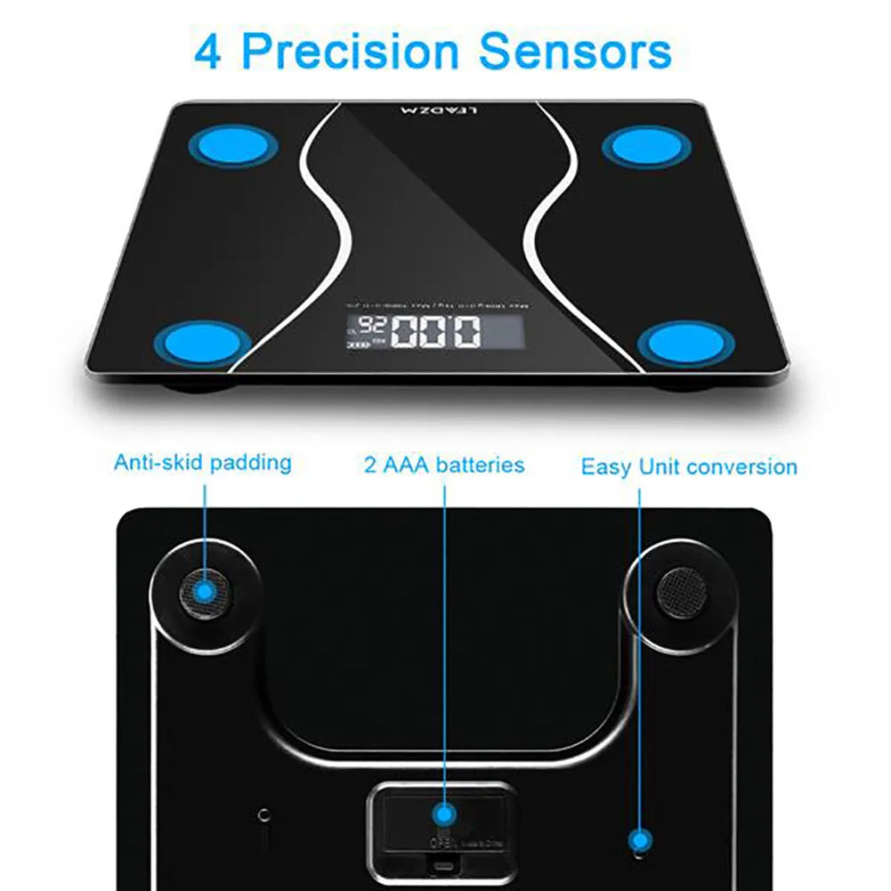 Black electronic digital bathroom scale with LCD display on a bathroom floor.