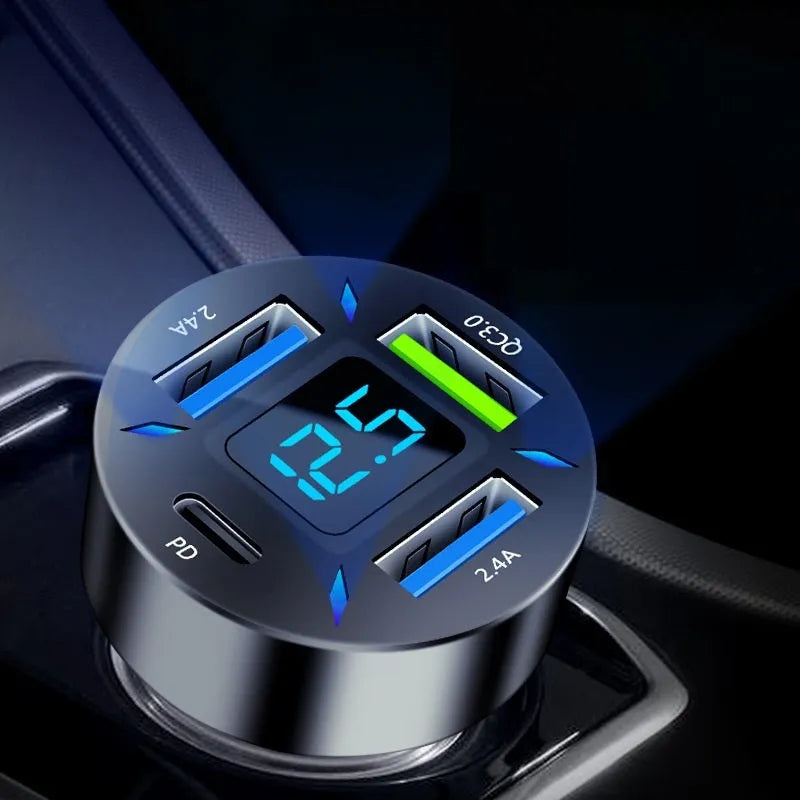 Black four-port USB car charger with LED digital display for 12V and 24V vehicles.