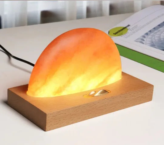 Sunrise Oriental wooden base table lamp with natural salt shade and built-in wireless phone charger.