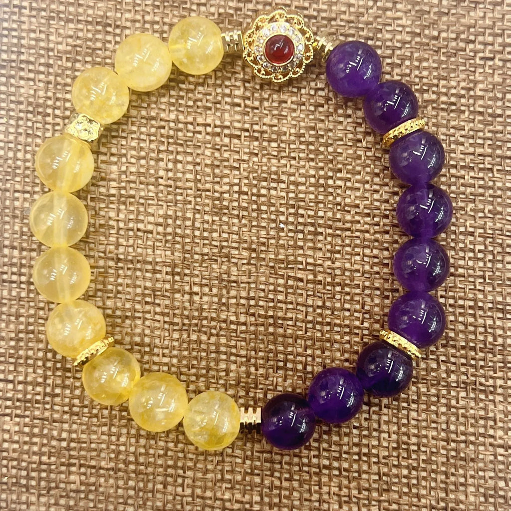 Handmade yellow and purple crystal bracelet for women on a wrist.